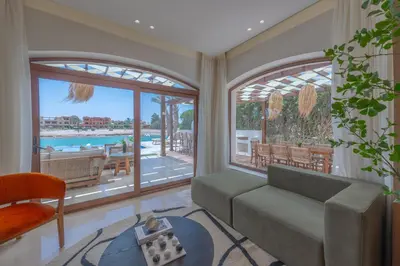 a living room with a couch and a view of a pool at Stunning Luxurious 5 BR Villa at West Golf El Gouna in Hurghada