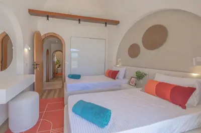 a bedroom with two beds and a bathroom at Stunning Luxurious 5 BR Villa at West Golf El Gouna in Hurghada
