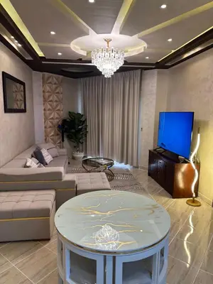 a living room with a couch and a tv at Sahl Hasheesh, El Andalous by sea and pool view, private beach in Hurghada