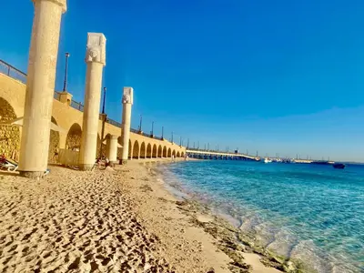 a view of a beach with pillars and the ocean at Sahl Hasheesh, El Andalous by sea and pool view, private beach in Hurghada