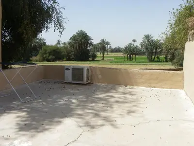 a microwave oven sitting on top of a patio at maison luxor in Al Aqālitah