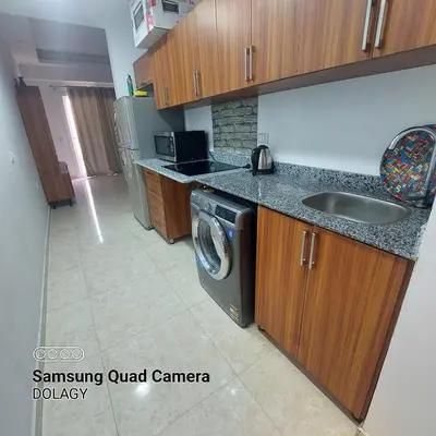 a kitchen with a sink and a washing machine at Selena bay resort in Hurghada