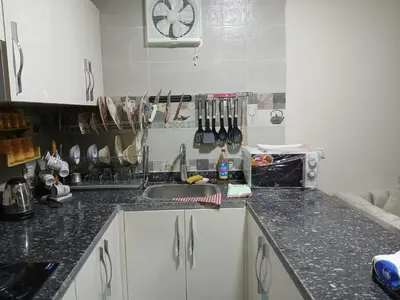 a kitchen with a sink and a counter top at Hossam Cozy Apartment El Hadaba Sheraton in Hurghada