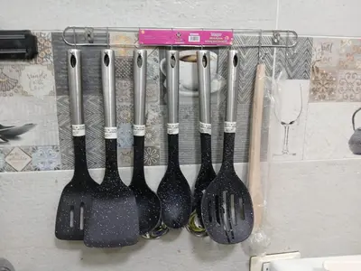 a group of utensils hanging on a wall at Hossam Cozy Apartment El Hadaba Sheraton in Hurghada