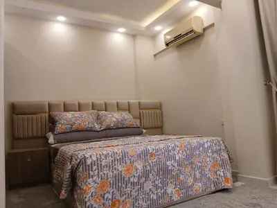 a bedroom with a bed with a blanket on it at Hossam Cozy Apartment El Hadaba Sheraton in Hurghada