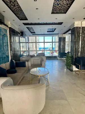 a lobby with couches and a table and windows at Juliana Beach Hurghada in Hurghada
