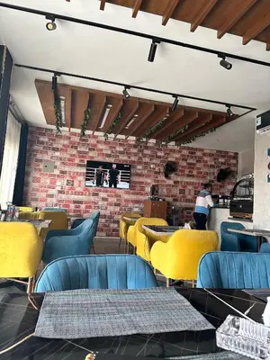 a restaurant with tables and chairs and a brick wall at Juliana Beach Hurghada in Hurghada