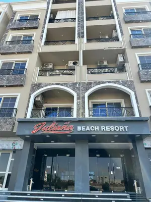 a building with a beach resort sign on it at Juliana Beach Hurghada in Hurghada