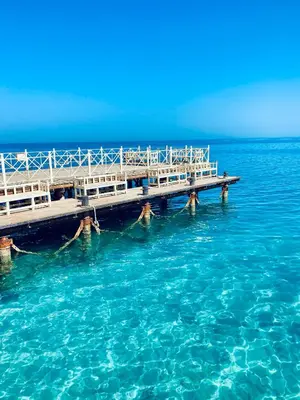 a group of people in the water near a pier at Apartment in el karma aqua beach resort hurghada near el gouna 2 in Hurghada