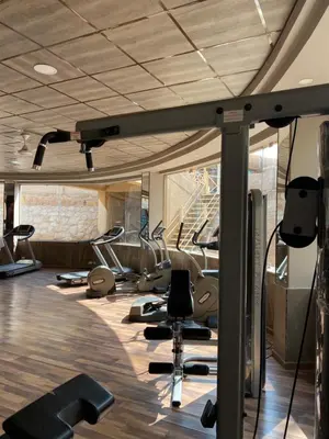a gym with a bunch of treadmills and ellipticals at Apartment in el karma aqua beach resort hurghada near el gouna 2 in Hurghada