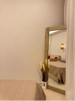 a bedroom with a mirror and a bed at Tolles Modernes Studio in Selena Bay in Hurghada