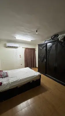 a bedroom with a bed in a room with a window at Super Elite apartment Nile View F6 in Naj‘ al ‘Amrāb