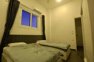 a room with two beds and a window at Sultan Guest House in Luxor