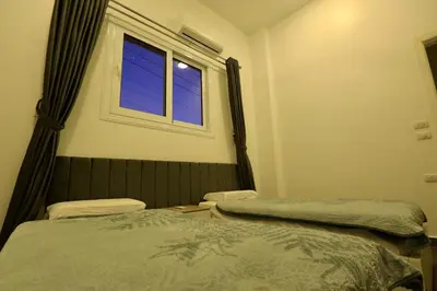 a bedroom with two beds and a window at Sultan Guest House in Luxor