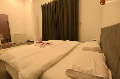 a bed with a stuffed animal on top of it at Sultan Guest House in Luxor