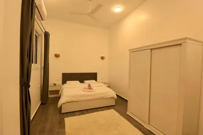 a bedroom with a bed with a pink towel on it at Sultan Guest House in Luxor