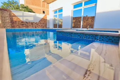 a swimming pool with blue tiles in a house at Sultan Guest House in Luxor