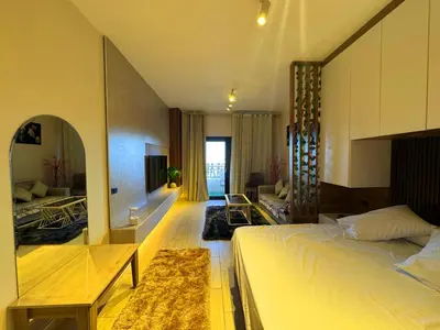 a bedroom with a bed and a living room at Aldau Sunset in Hurghada