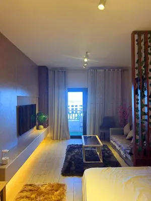 a living room with a bed and a couch at Aldau Sunset in Hurghada