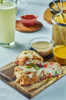 a cutting board with a piece of food on it at Al Fanar Azur Hotel in Suwhaj