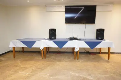 a table with two speakers and a screen on a wall at Al Fanar Azur Hotel in Suwhaj