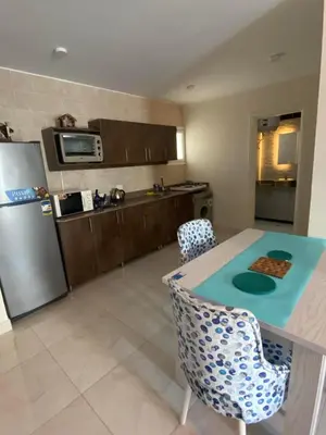 a kitchen with a table and a refrigerator at Red sea-Cozy one bedroom with sea view in Hurghada