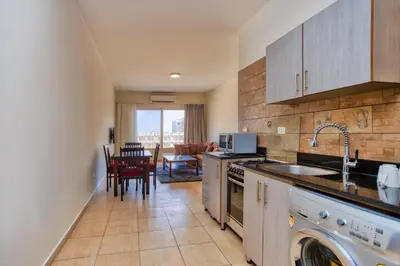 a kitchen with a sink and a dishwasher at Delmar Apartments by Peaks in Hurghada