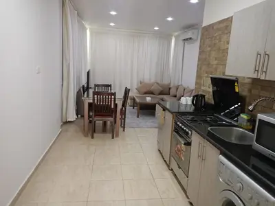a kitchen and living room with a couch and a table at Delmar Apartments by Peaks in Hurghada
