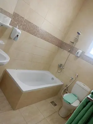 a bathroom with a tub and a toilet and a sink at Delmar Apartments by Peaks in Hurghada