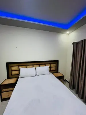 a bedroom with a white bed with a blue ceiling at Rosa Hotel Hurghada in Hurghada