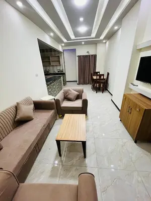a living room with couches and a table and a tv at Rosa Hotel Hurghada in Hurghada