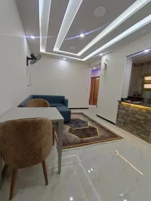 a living room with a table and a couch at Rosa Hotel Hurghada in Hurghada