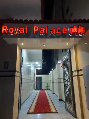 a royal palace entrance with a red neon sign at Rosa Hotel Hurghada in Hurghada