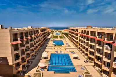a view of a swimming pool between two buildings at Selena bay apartment beach in Hurghada