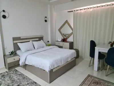 a bedroom with a bed and a table and a desk at Selena bay apartment beach in Hurghada