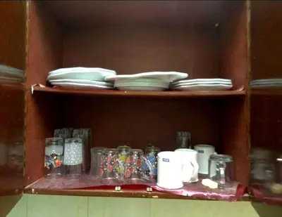 a wooden shelf with plates and dishes on it at La Veranda \u967d\u53f0 in Aswan
