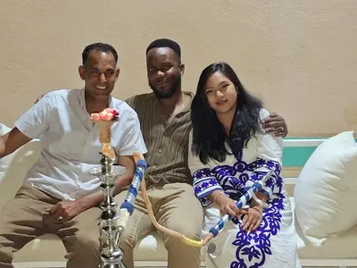 a group of three people sitting on a couch at ATON PALACE Luxor in Luxor