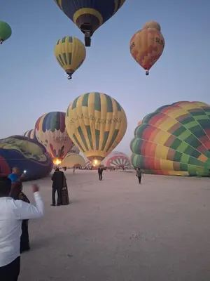 a group of hot air balloons flying in the sky at ATON PALACE Luxor in Luxor