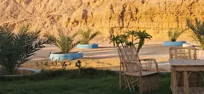 two chairs and a table in front of some plants at ATON PALACE Luxor in Luxor