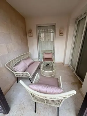 three wicker chairs and tables in a room at Scarab El Gouna in Hurghada