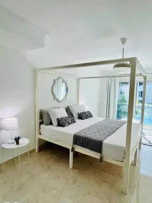 a white bedroom with a bed with a canopy at Hurghada Stylish stay in Hurghada
