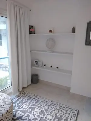 a living room with white walls and a rug at Hurghada Stylish stay in Hurghada