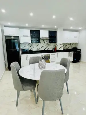 a kitchen with a table and chairs in a kitchen at Hurghada Stylish stay in Hurghada