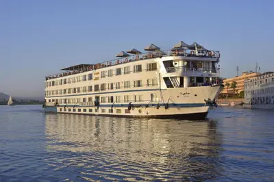 a large white cruise ship in the water at Hapi V in Aswan