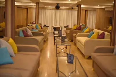 a row of couches in a room with colorful pillows at Hapi V in Aswan
