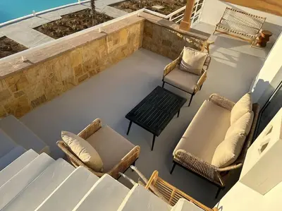 a patio with two chairs and a bench on a roof at Penthouse 3 Bedrooms in Swan Lake ElGouna in Hurghada