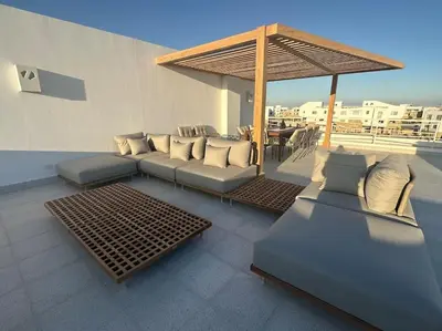 a patio with couches and a pavilion on a roof at Penthouse 3 Bedrooms in Swan Lake ElGouna in Hurghada