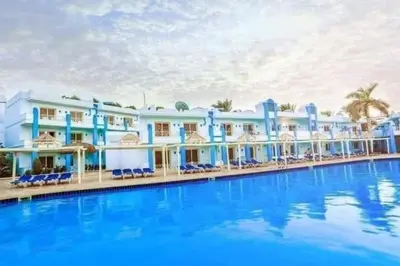 a large hotel with a large swimming pool at شاليه في منتجع ميراج in Hurghada