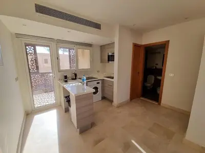a large kitchen with a island in a room at EL GOUNA Scarab Club One bedroom in Hurghada