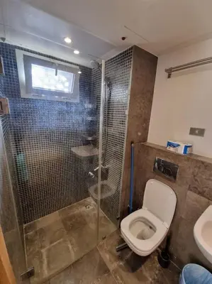 a bathroom with a shower and a toilet and a sink at EL GOUNA Scarab Club One bedroom in Hurghada